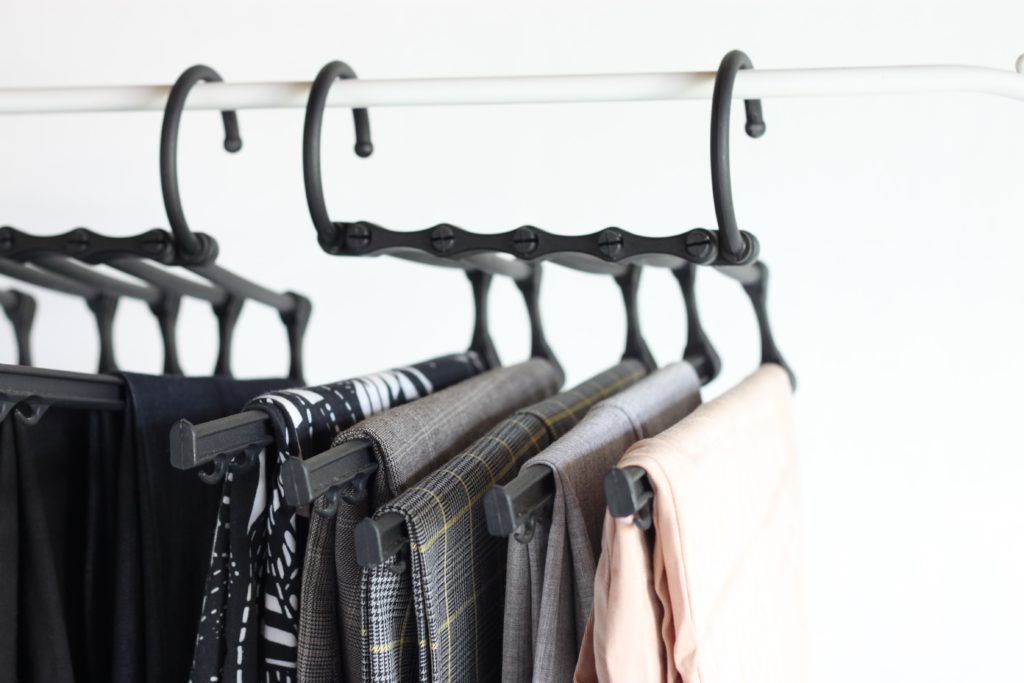 Use space-saving pant hangers to maximize storage 