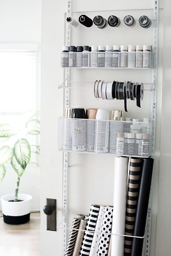 Your closet doors are goldmines for hidden storage to maximize space in a small bedroom while keeping your belongings out of sight.