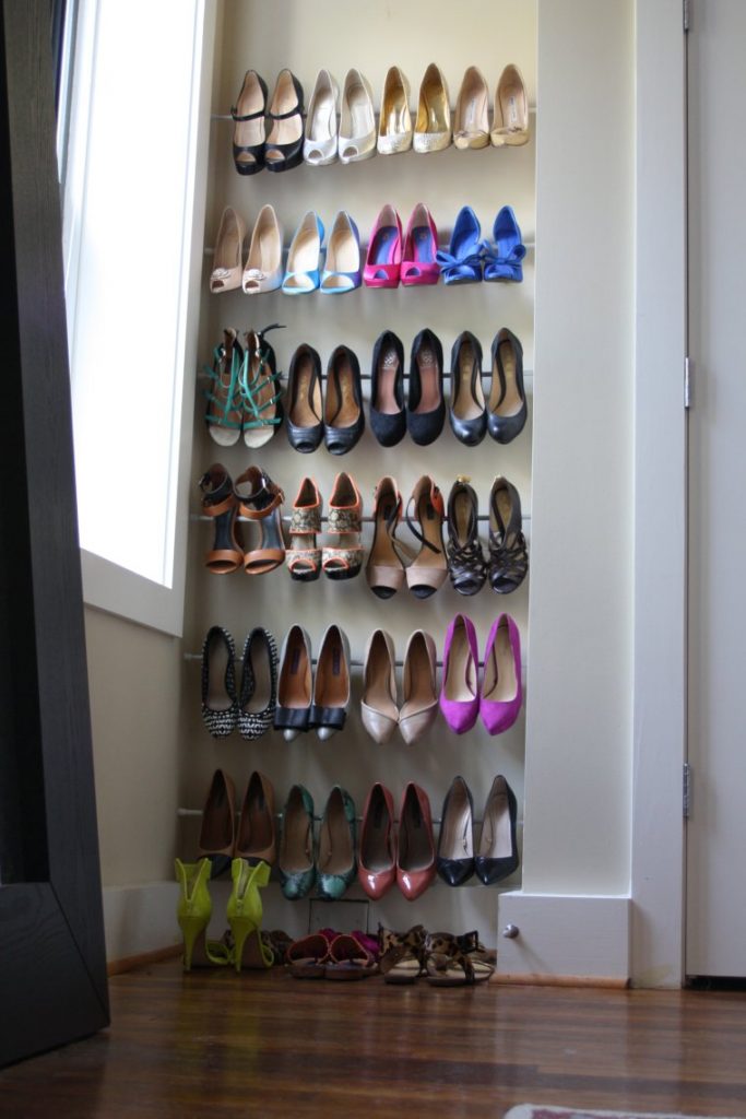Store shoes on tension rods in a small bedroom