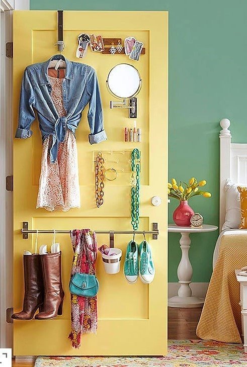 Your closet doors are goldmines for hidden storage to maximize space in a small bedroom