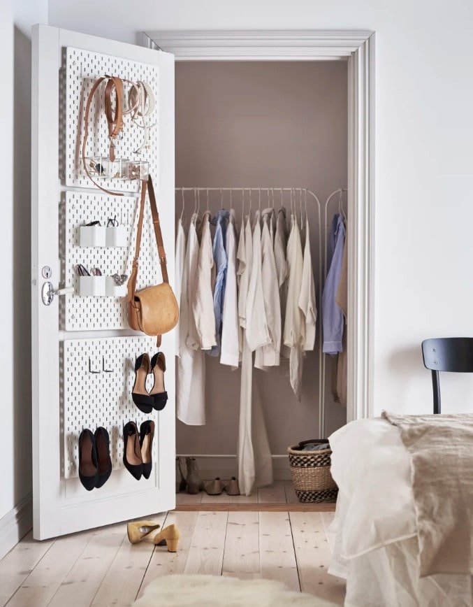 Your closet doors are goldmines for hidden storage to maximize space in a small bedroom and these ikea pegboards are a great storage option for your closet